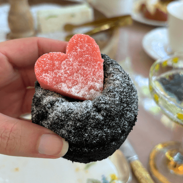 Dark chocolate bundt cake with strawberry heart and fresh berries
