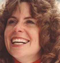 Mollie McCarty looking up, smiling