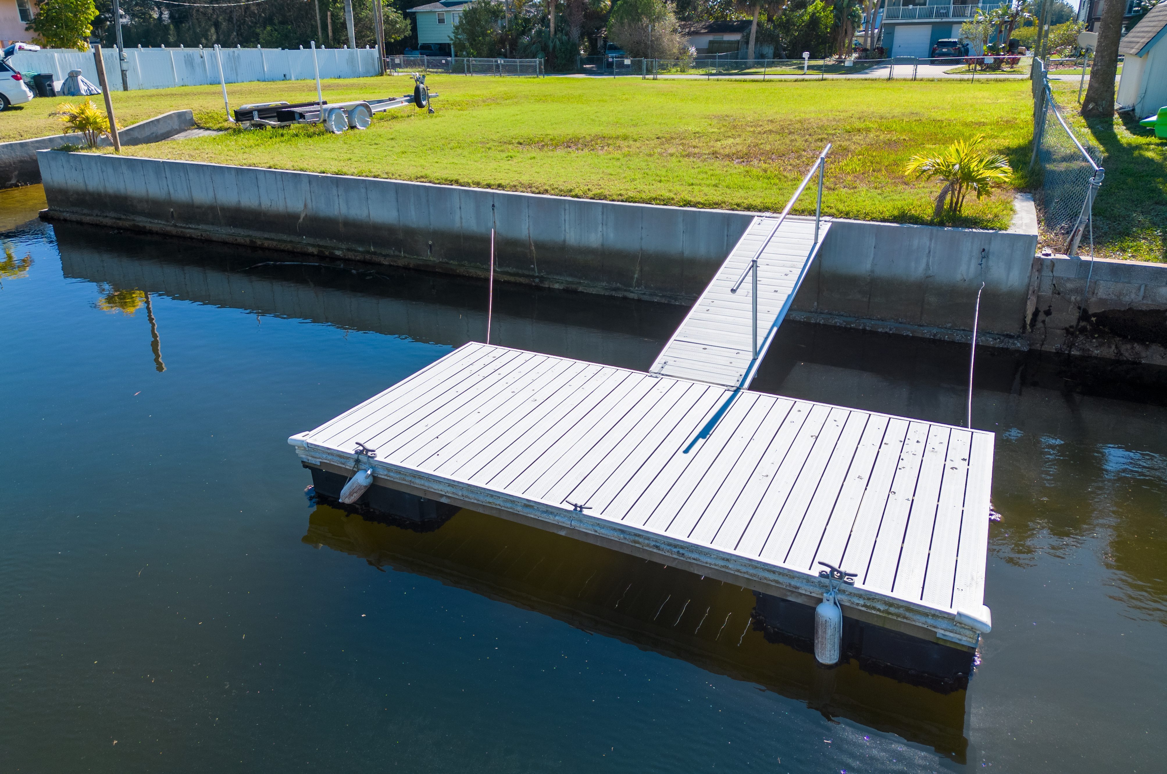 Floating boat dock with concrete sea wall in Florida