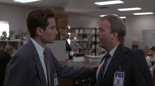 Mulder confronts Jerry, grabbing the lapel of his coat.