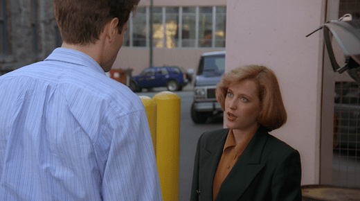 Scully is looking up at Mulder.