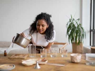 woman in white shirt holding a cooking pot