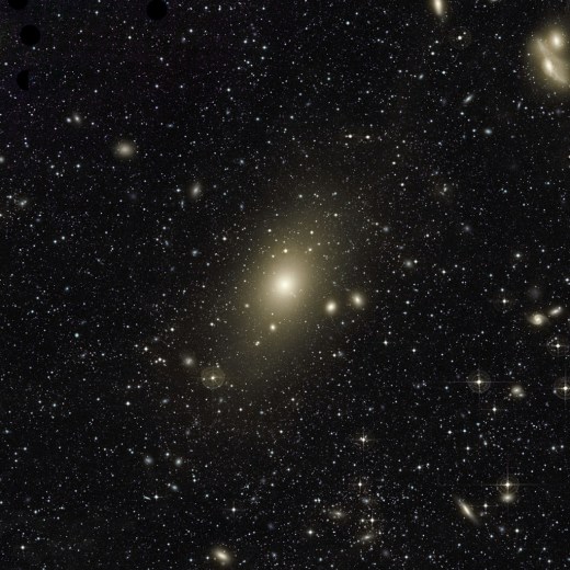 The huge halo around giant elliptical galaxy Messier 87 appears on this very deep image. An excess of light in the top-right part of this halo, and the motion of planetary nebulae in the galaxy, are the last remaining signs of a medium-sized galaxy that recently collided with Messier 87. The image also reveals many other galaxies forming the Virgo Cluster, of which Messier 87 is the largest member. In particular, the two galaxies at the top right of the frame are nicknamed "the Eyes".