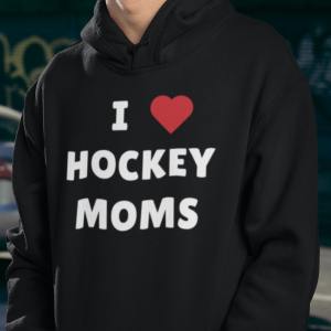 a young man in an "I love hockey moms" black hockey hoodie. He has sunglasses and a gray hat on.