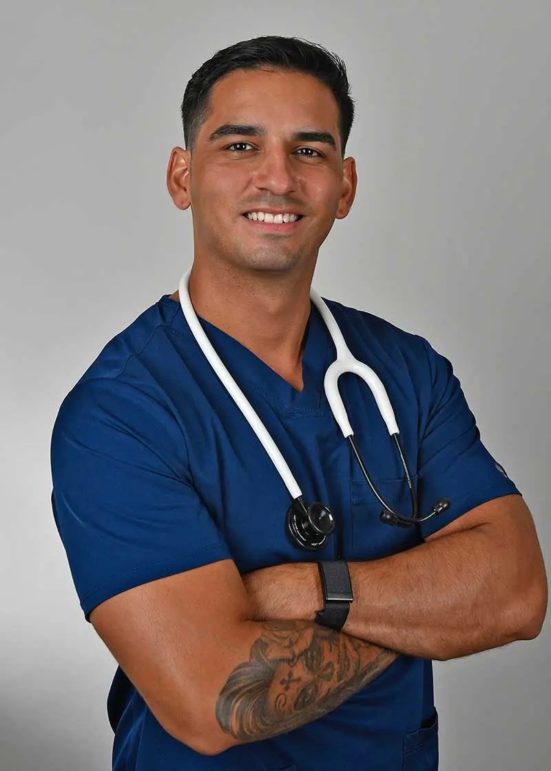 new-ralph-image A nurse in blue scrubs with a stethoscope stands confidently, representing Holy City Healthcare Consultants, a concierge medical practice specializing in in-home medical care and hormone therapy.| Holy City Healthcare Consultants Charleston, SC