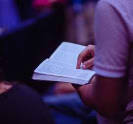 selective focus photo of person holding book