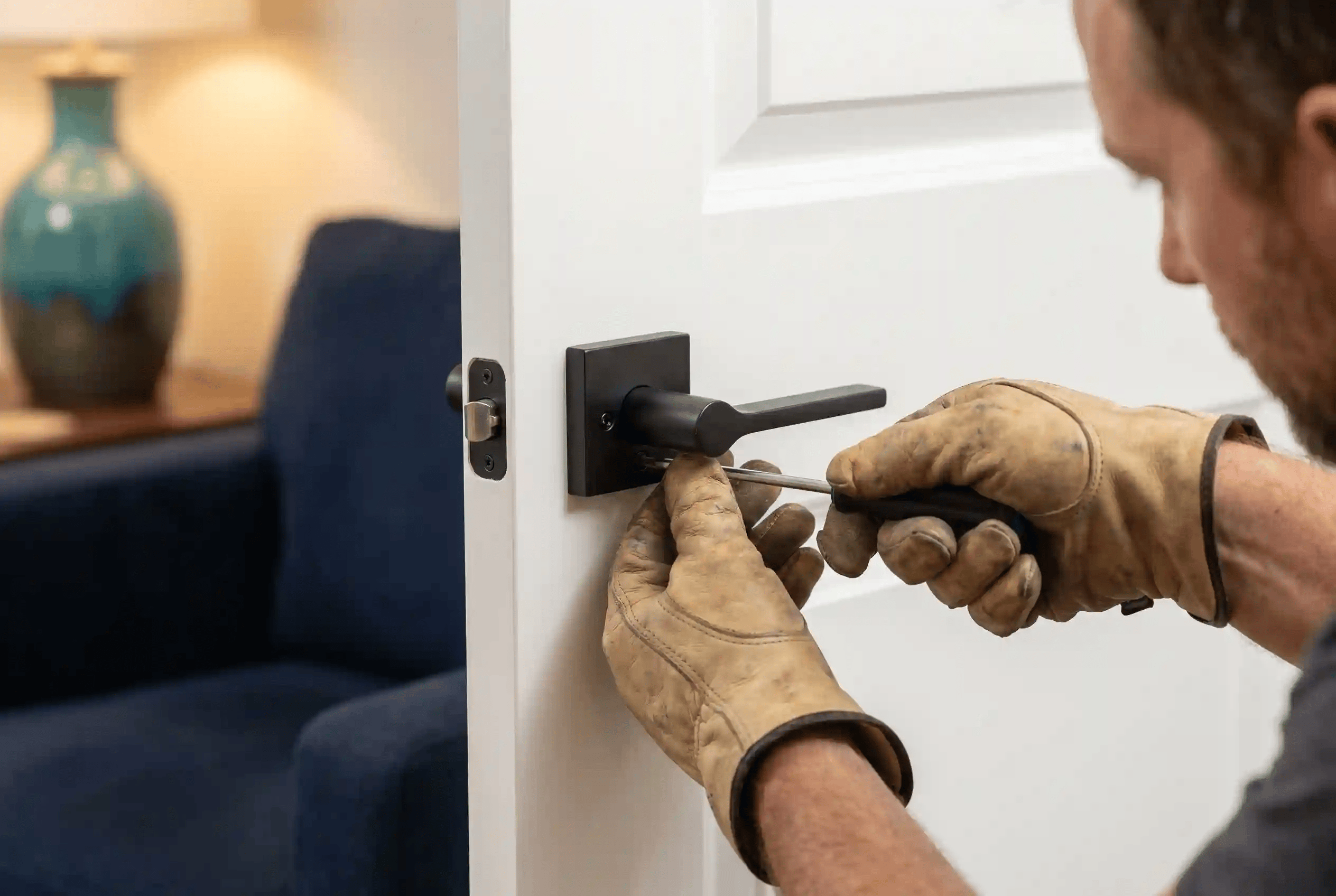 Handyman patching drywall and painting a wall