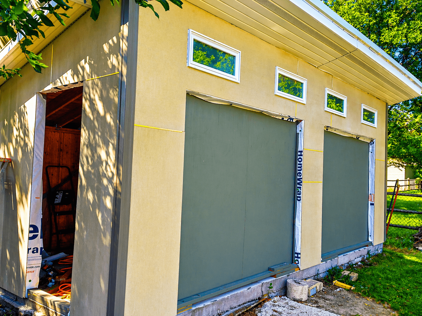Exterior walls partially painted yellow over Hardie panels