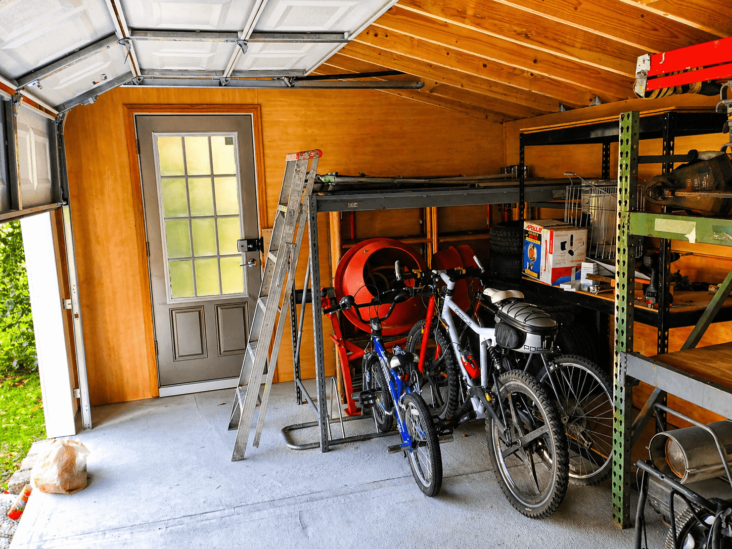 Inside the shed today through open garage door showing storage and use