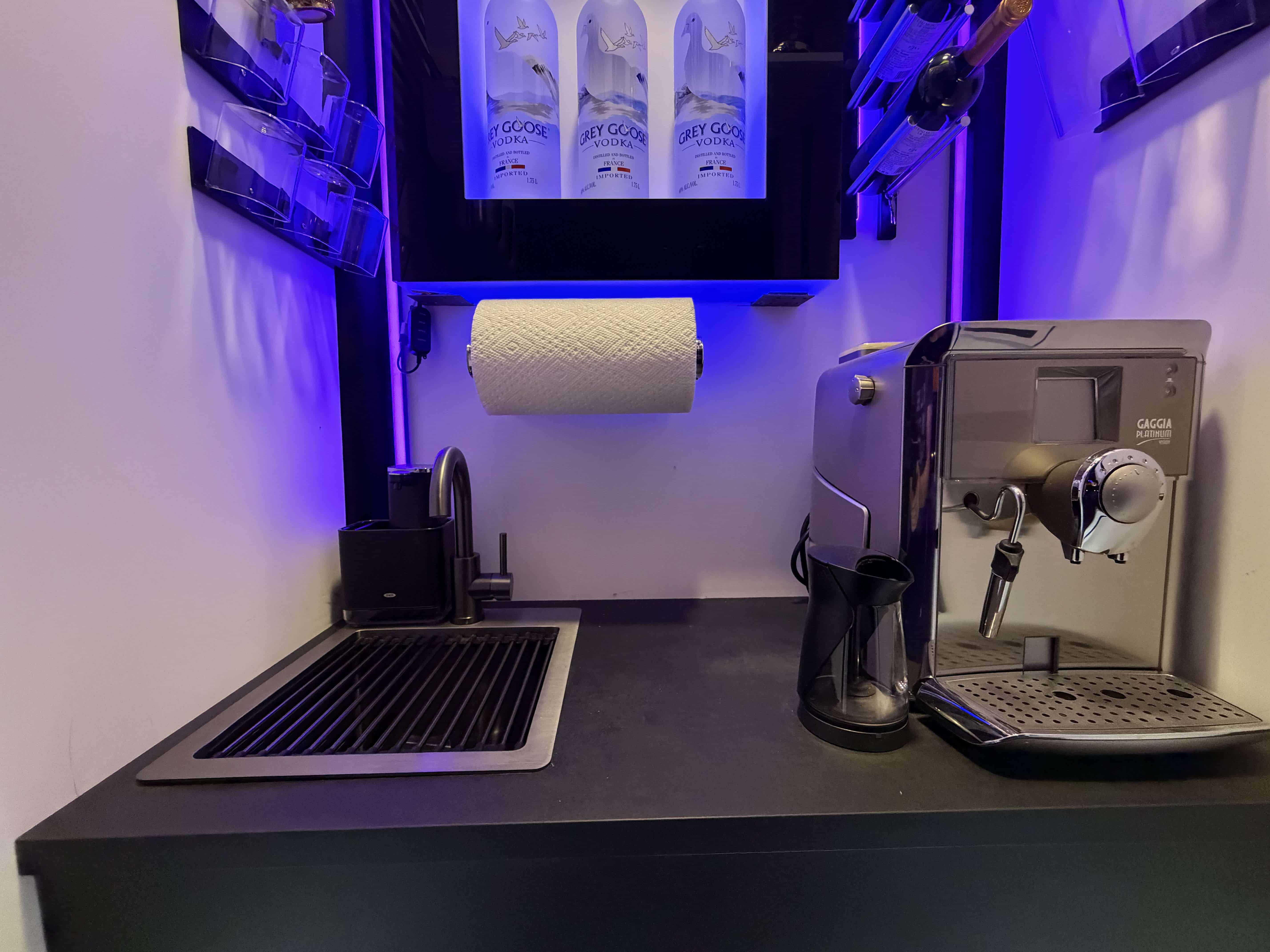 Compact black sink with matte black faucet in patio bar