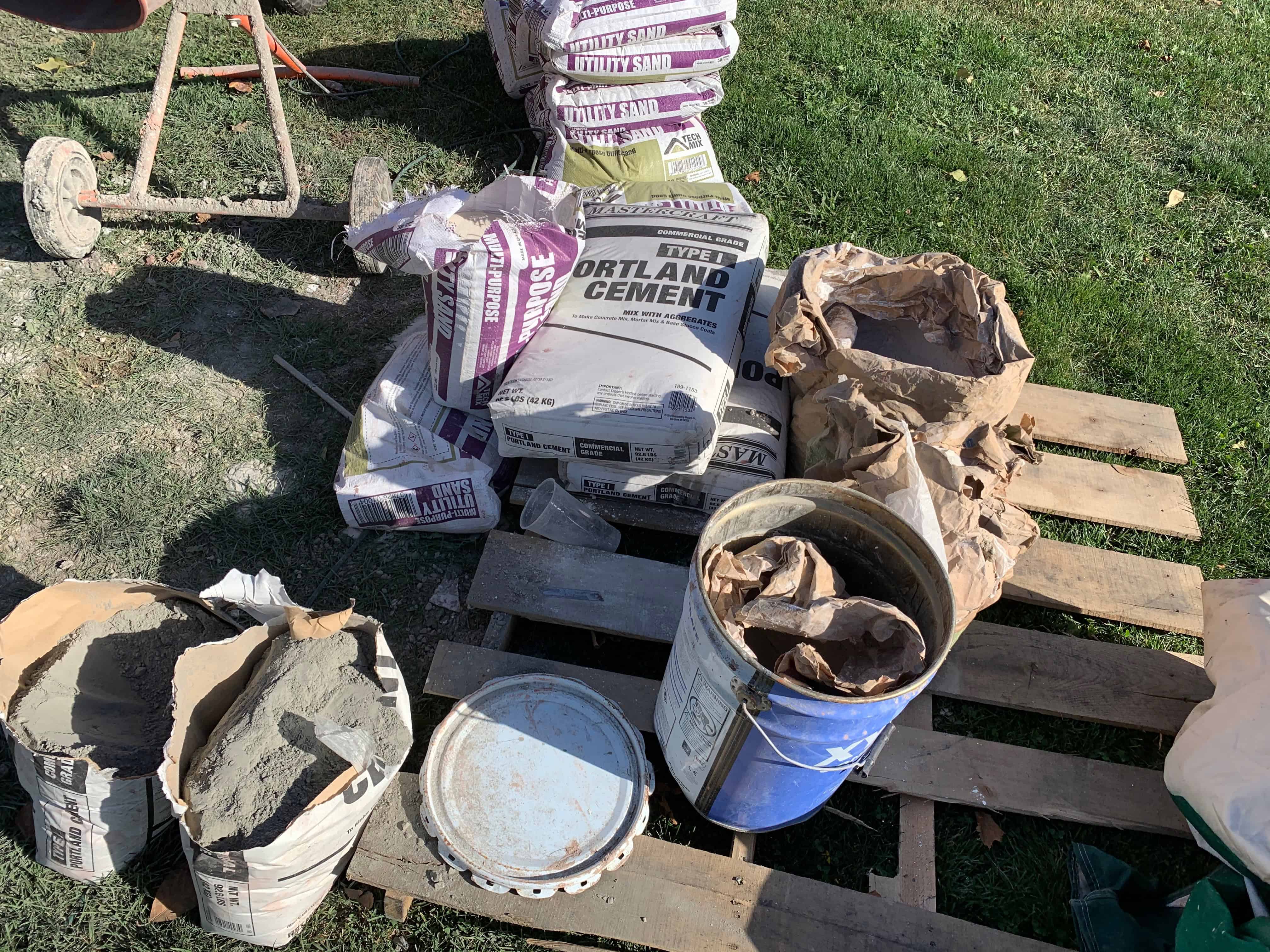 Mixing concrete in a small electric mixer and wheelbarrow for the fountain build.