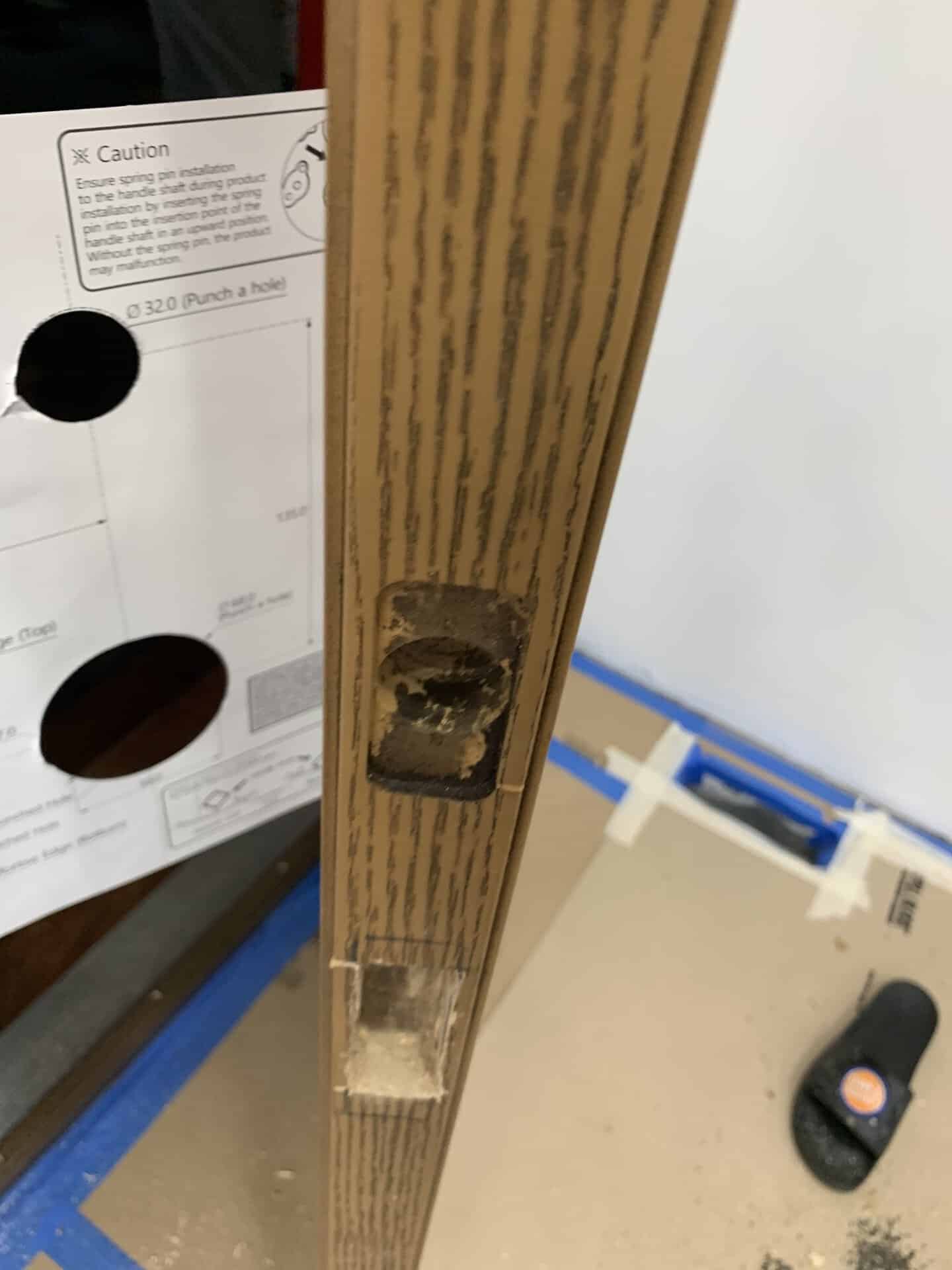 Damaged wooden furniture leg with missing hardware and visible hole.