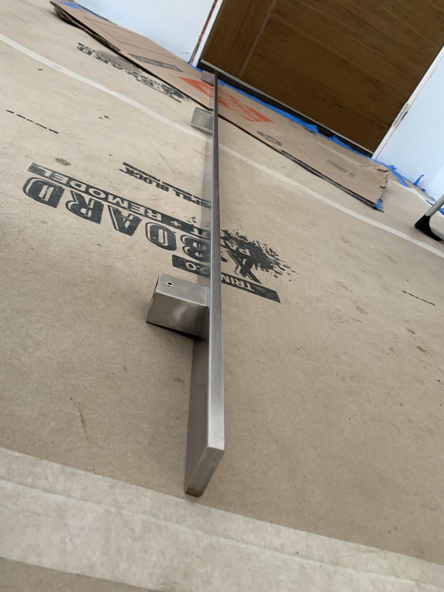 Sleek stainless steel door handle installed on a door.