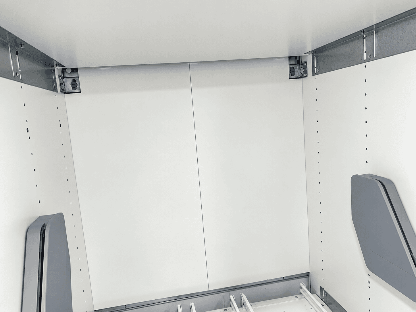 Kesseböhmer iMove side mounting brackets with their snap-on plastic covers fitted to the inner walls of an IKEA SEKTION cabinet