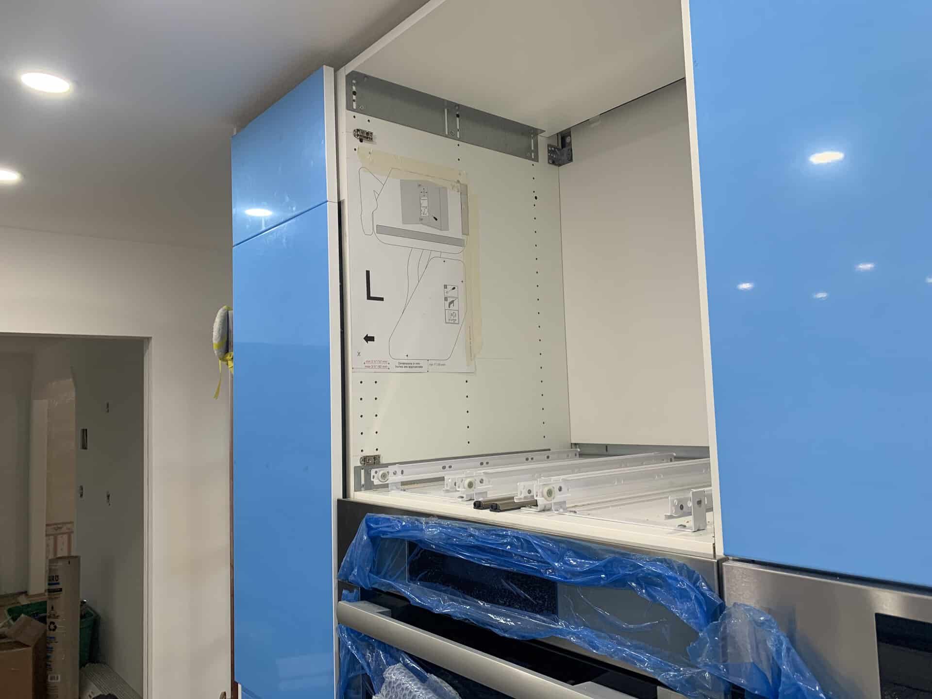 Kesseböhmer paper drilling template taped to the inner wall of the SEKTION cabinet