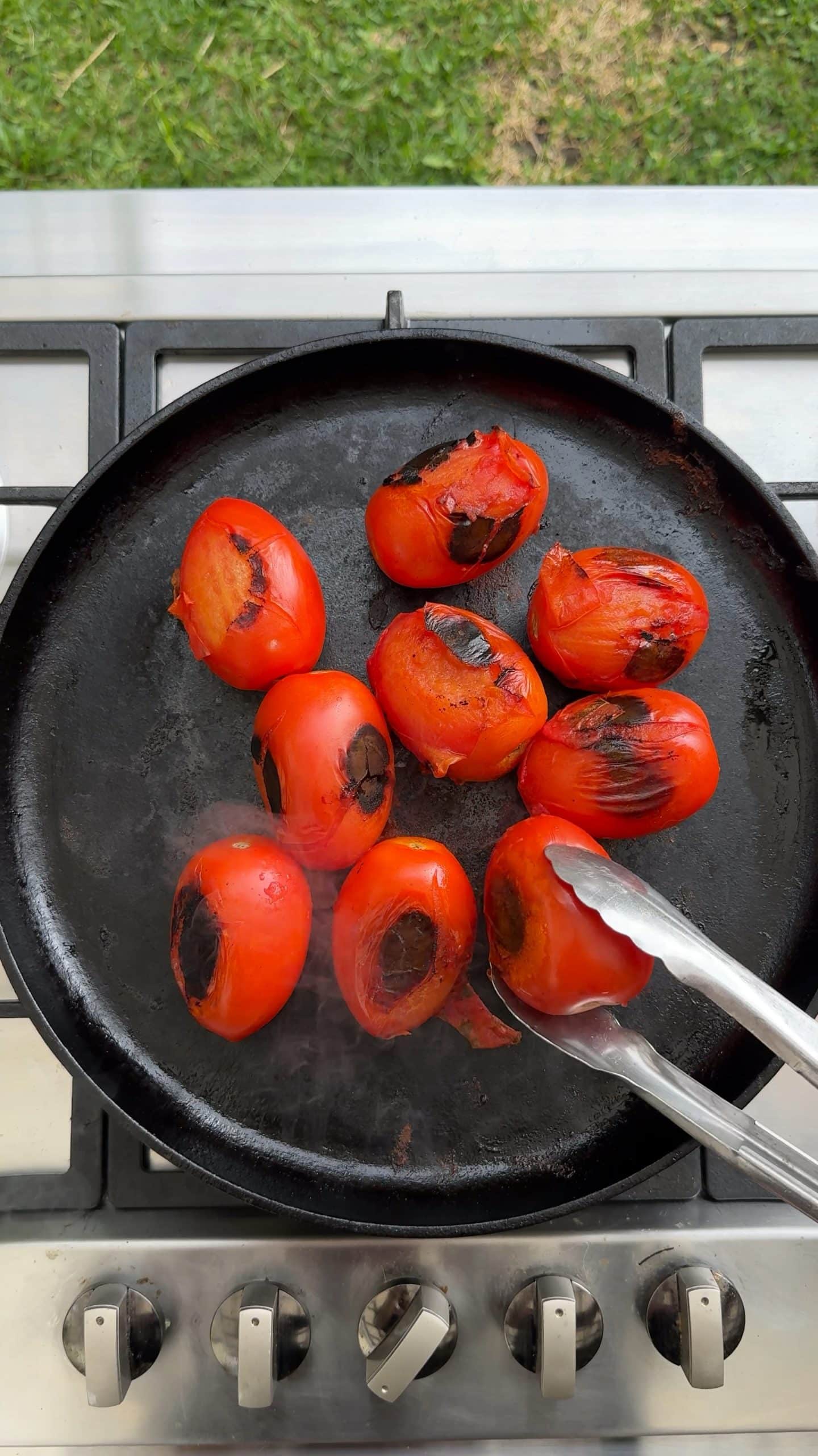 Roma tomatoes charred on a comal for the Estofado de Pollo sauce.