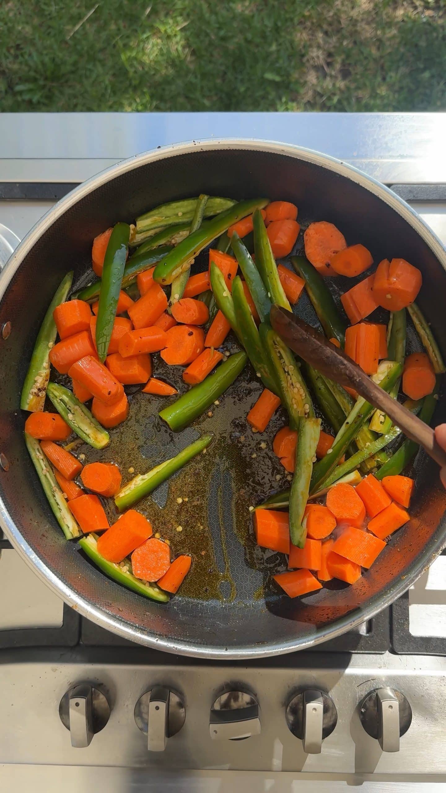 Carrots, jalapeños, and serrano peppers sautéing in chicken drippings.