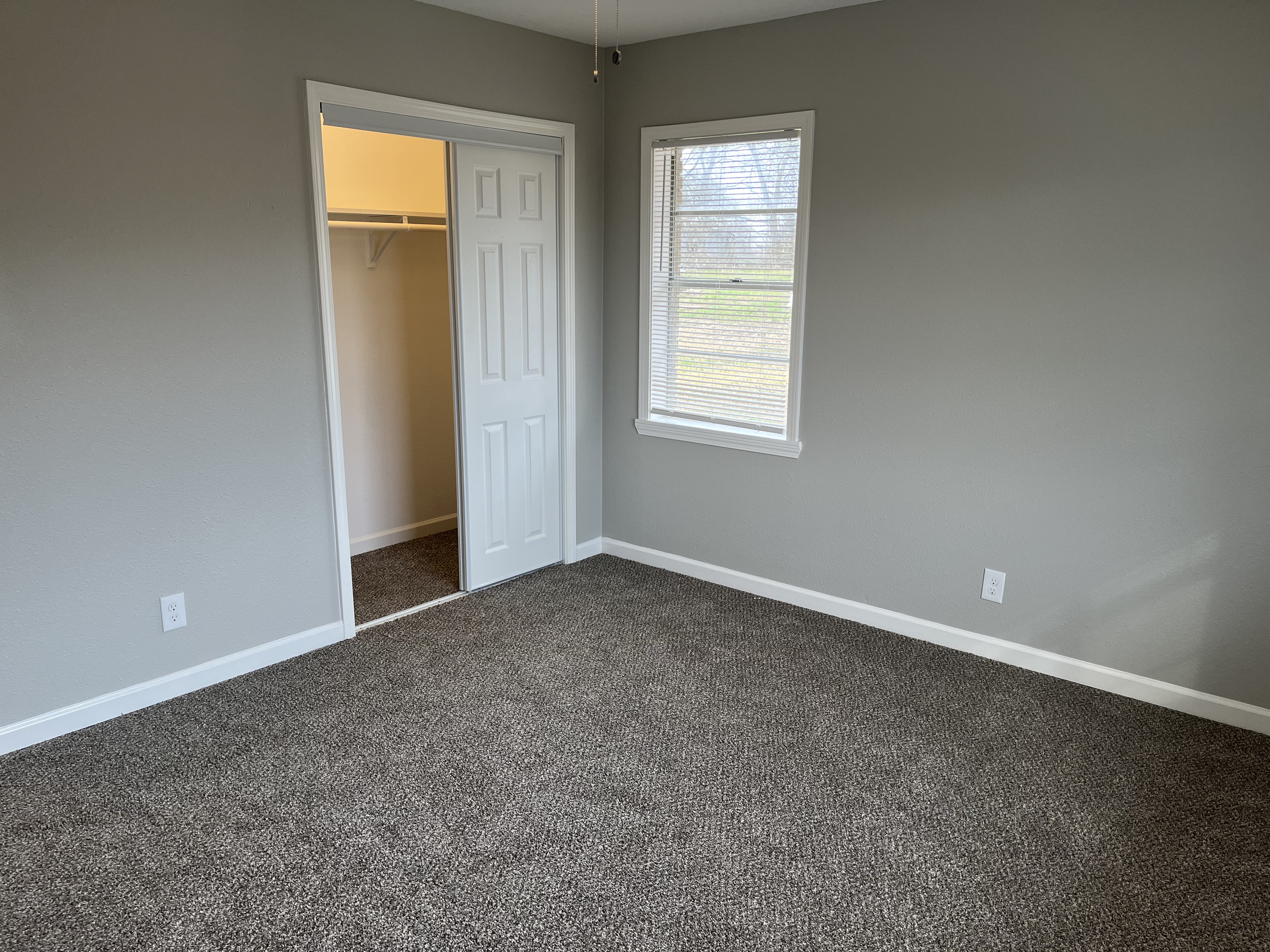 The secondary bedrooms are identical and include a closet in each bedroom with the shared bathroom just outside the door.