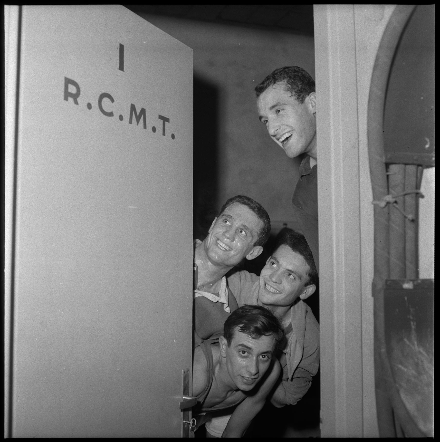 La porte du vestiaire, avec les joueurs du RCMT, 28 janvier 1960 - Photo André Cros – Ville de Toulouse, Archives municipales, 53Fi6586