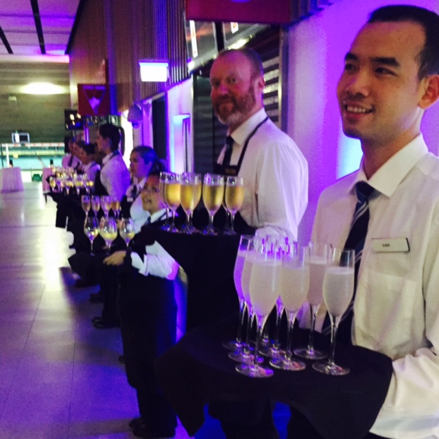 Waiters at the ready with trays of Mumm champagne.
