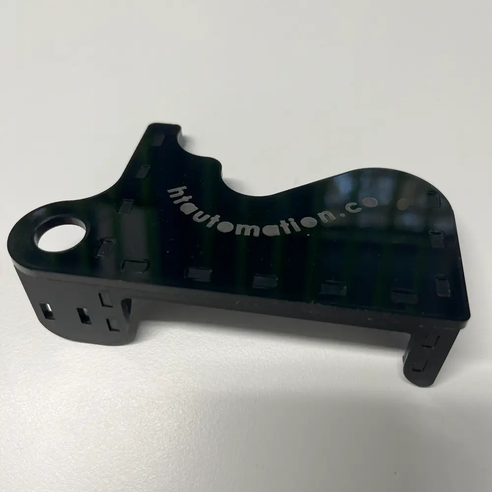 Laser accessory fixture assembly cut out of black cast acrylic sheet with htautomation.co engraved into top plate