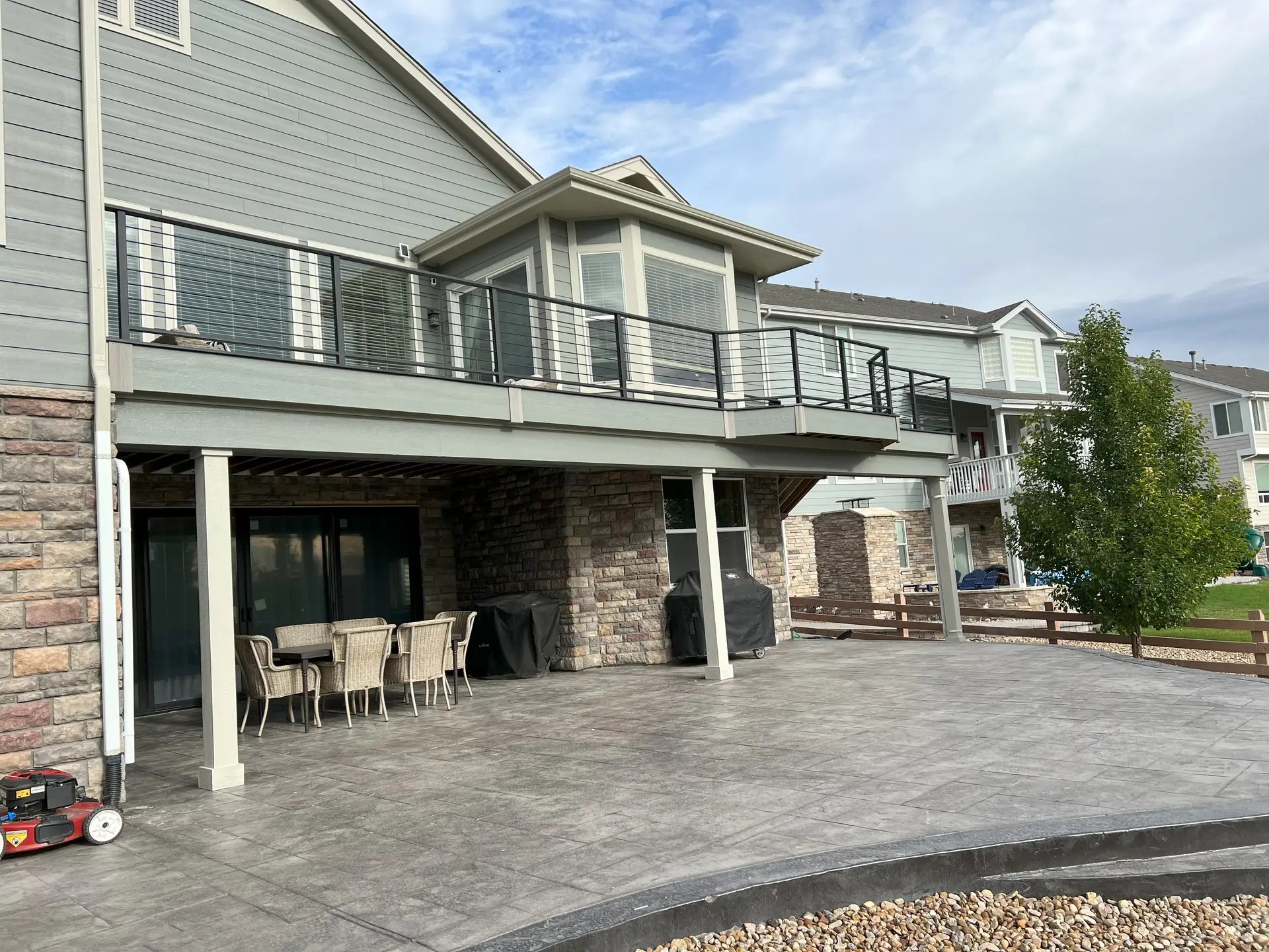 Large composite deck with stamped concrete patio