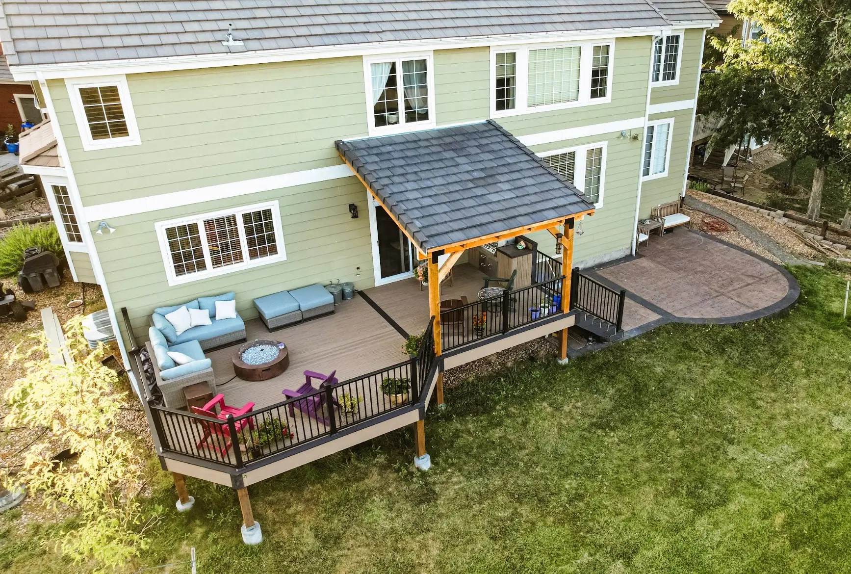 Custom deck with partial cover with built-in bbq and stamped concrete patio