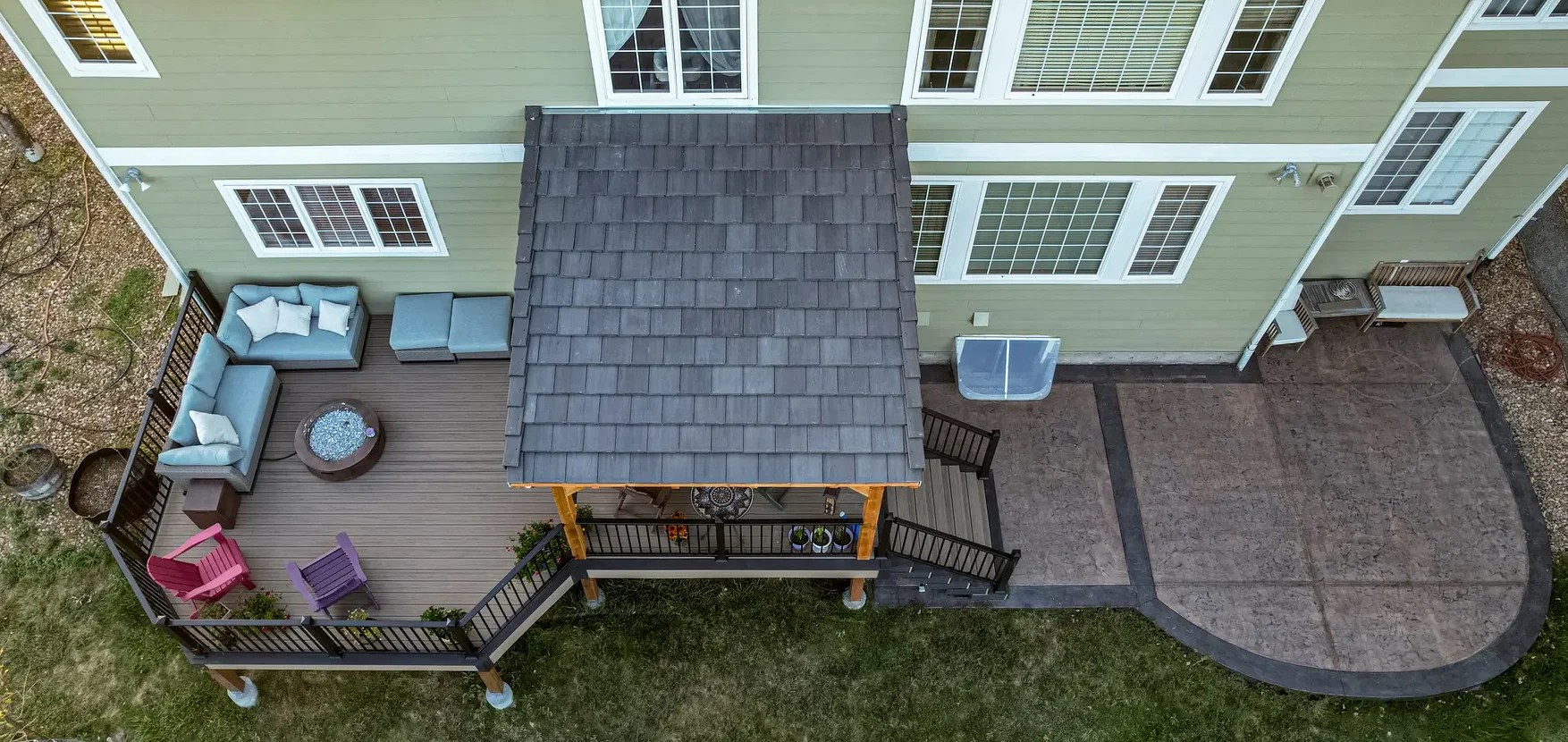 Drone image of deck and patio with a deck cover over half the deck