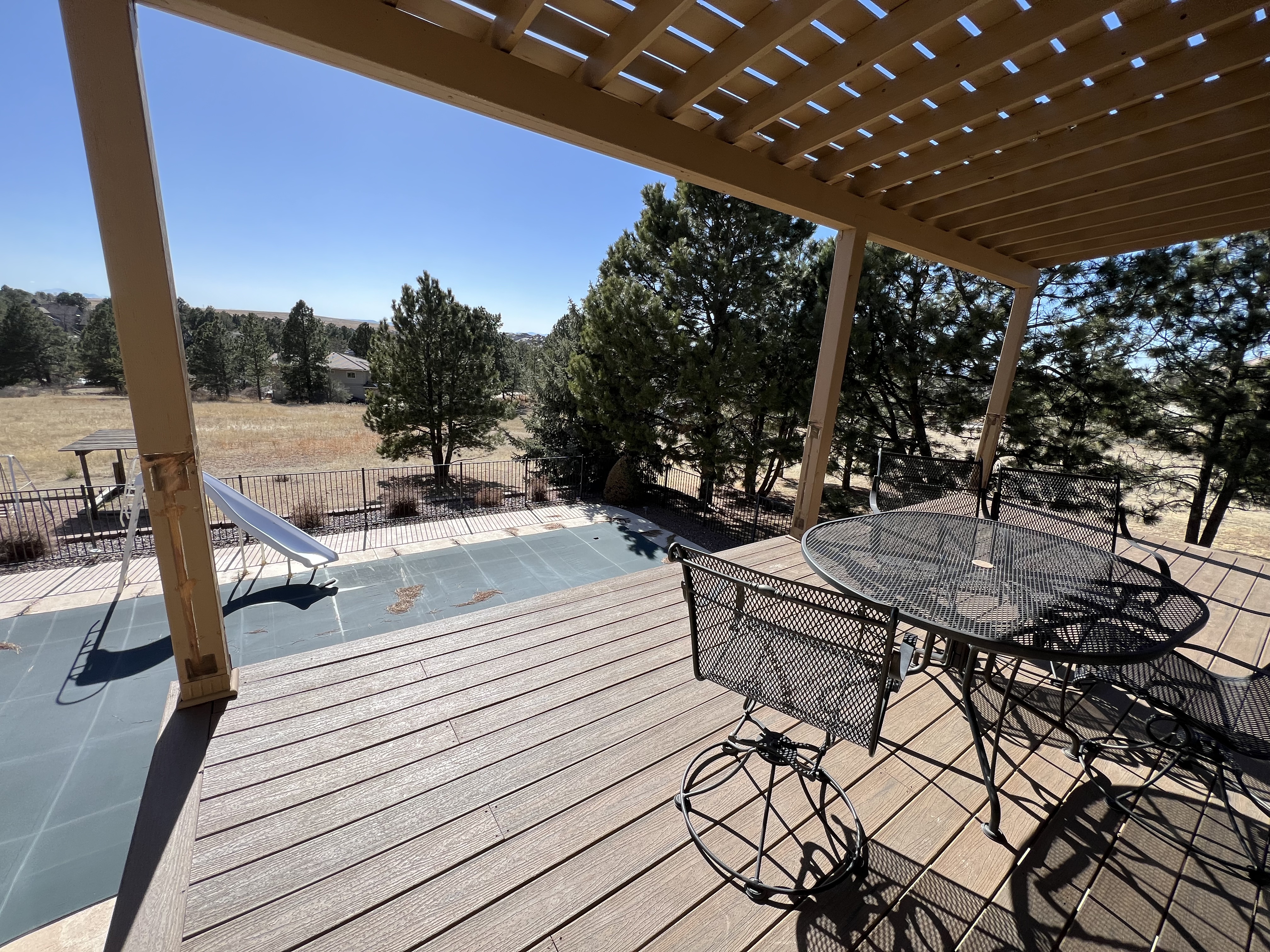 Second level composite deck with wood pergola and the railing removed.