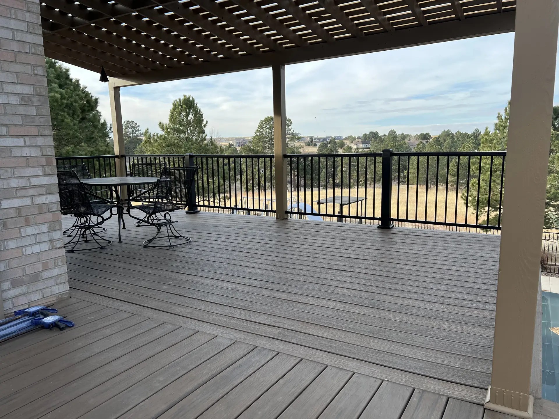 Composite deck with wood pergola black aluminum railing