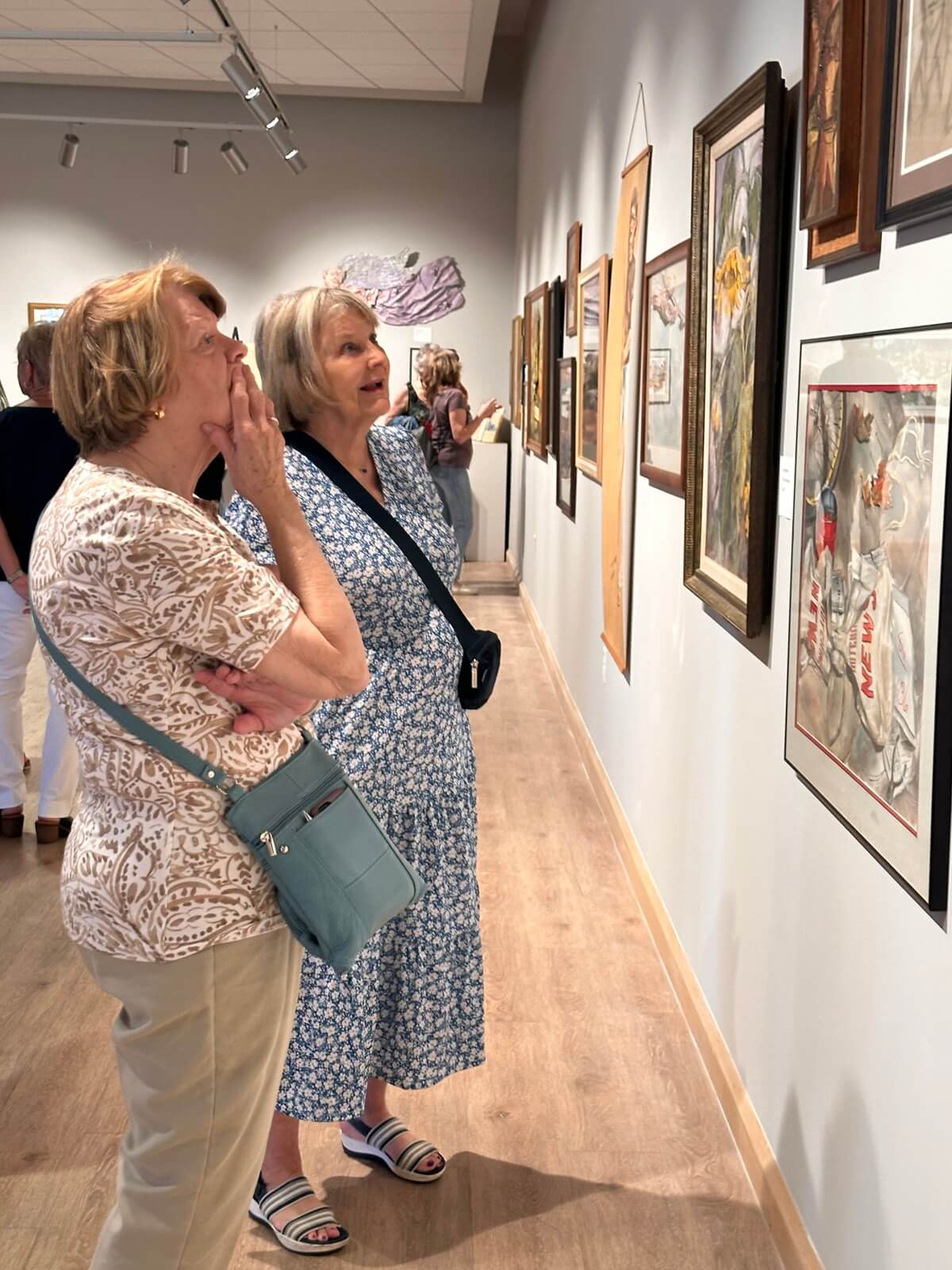 Guests of the exhibit admired Potucek's work. Approximately 170 guests attended. KELLI SNIDER-SHORT | THE HUTCHINSON TRIBUNE