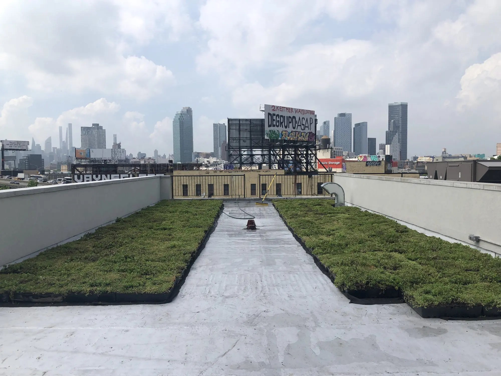 Installing a modular green roof tray system in Queens, 2022.