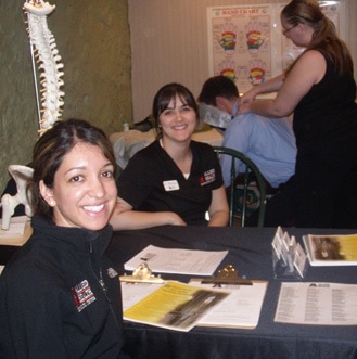 Students smiling in a classroom while participating in an herbal training