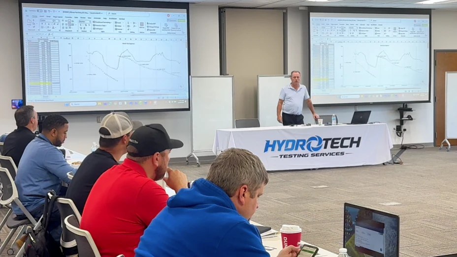Instructor reviewing pressure testing data and graphs during HydroTech course