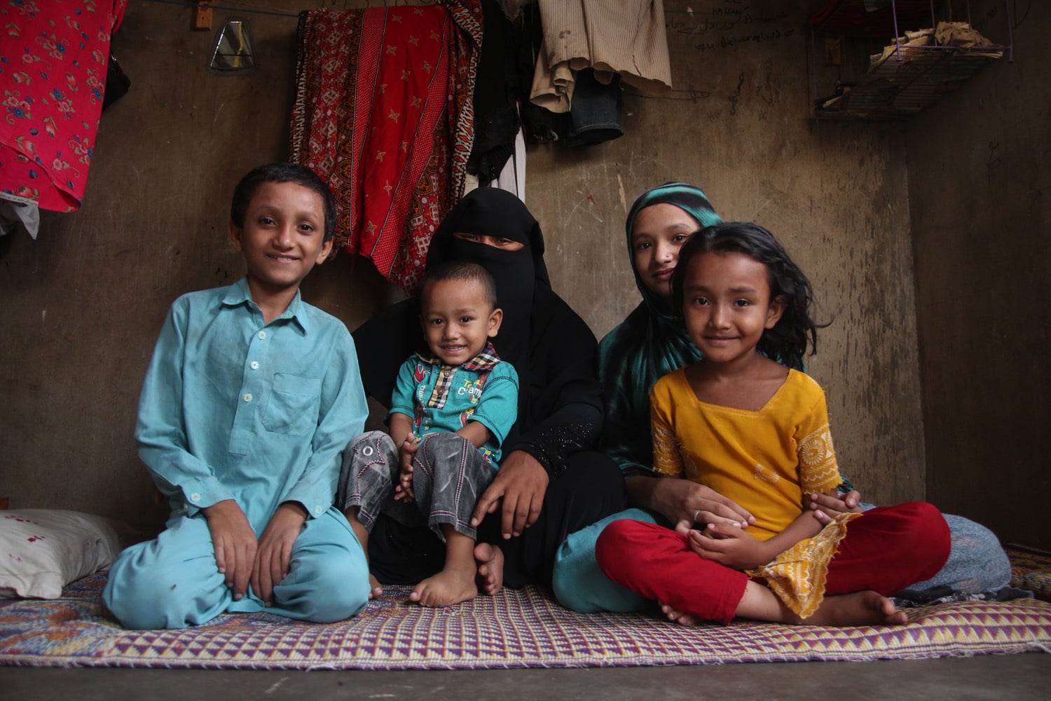 Anwara with her children in a single room quarter.