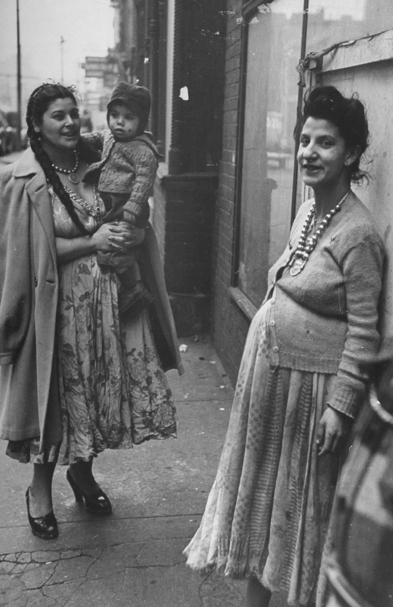 Two pregnant women stand on a sidewalk in 1946.