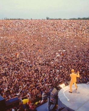 David Bowie stands before an audience of over 60,000 fans at the Milton Keynes Bowl on 2 July 1983