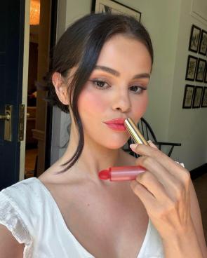 Selfie while applying lipstick – IG July 2026