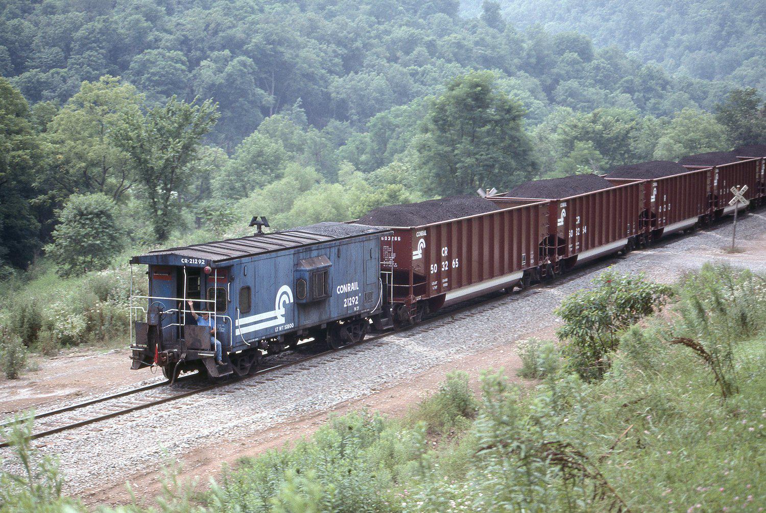 Conrail caboose 2192 at the rear of a coal train in Holbrook, Pennsylvania  on July 21, 1990. : rTrainPorn