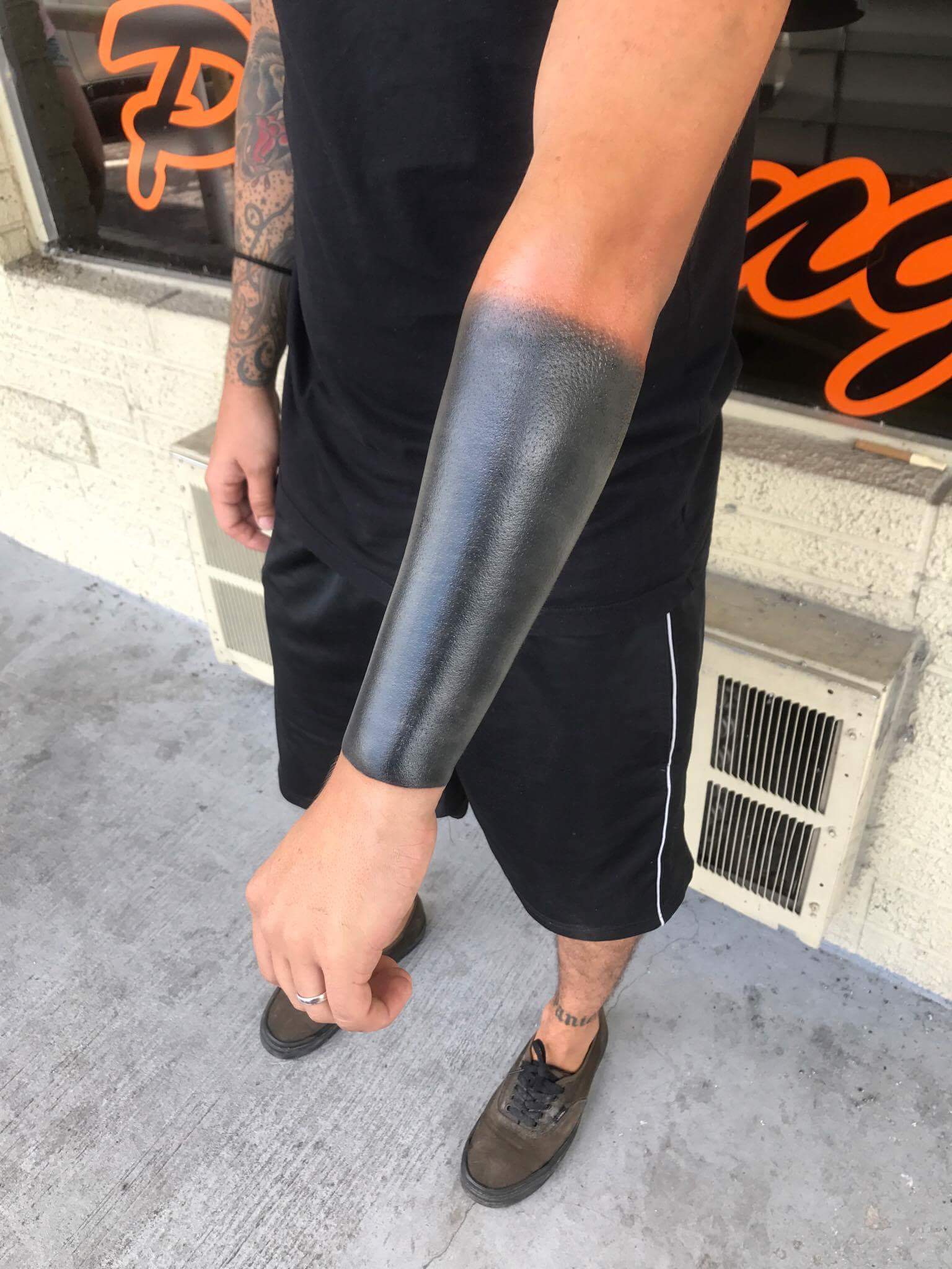 Blackout tattoo forearm