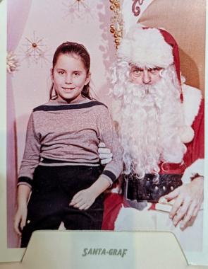 My mom c.1960 with the Grinchiest looking Santa Claus I’ve ever seen