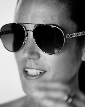 Shades on. But her aura off the charts