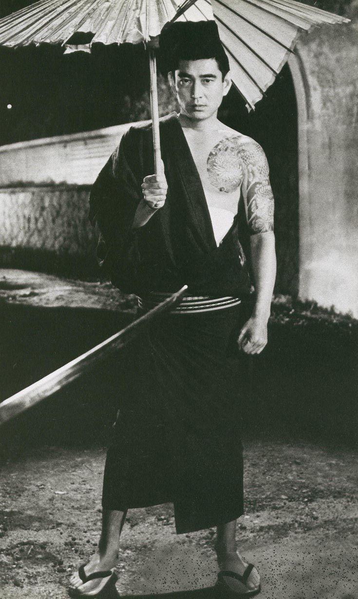 A young Takakura Ken (the actor) holding an umbrella. Remind you of anyone?  : rDandadan