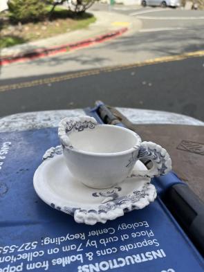 Teacup and saucer with human teeth ornamentation