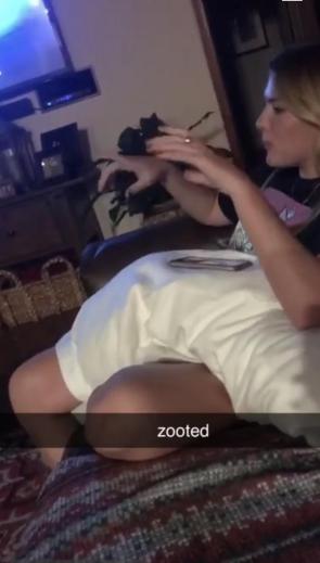 I thought there was someone laying on her lap in a white shirt