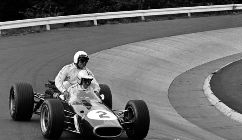 Denny Hulme Giving A Lift To Jack Brabham At 1967 German