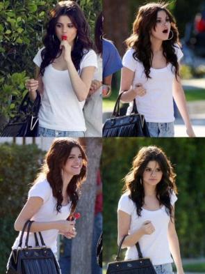 Selena is eating a lollipop