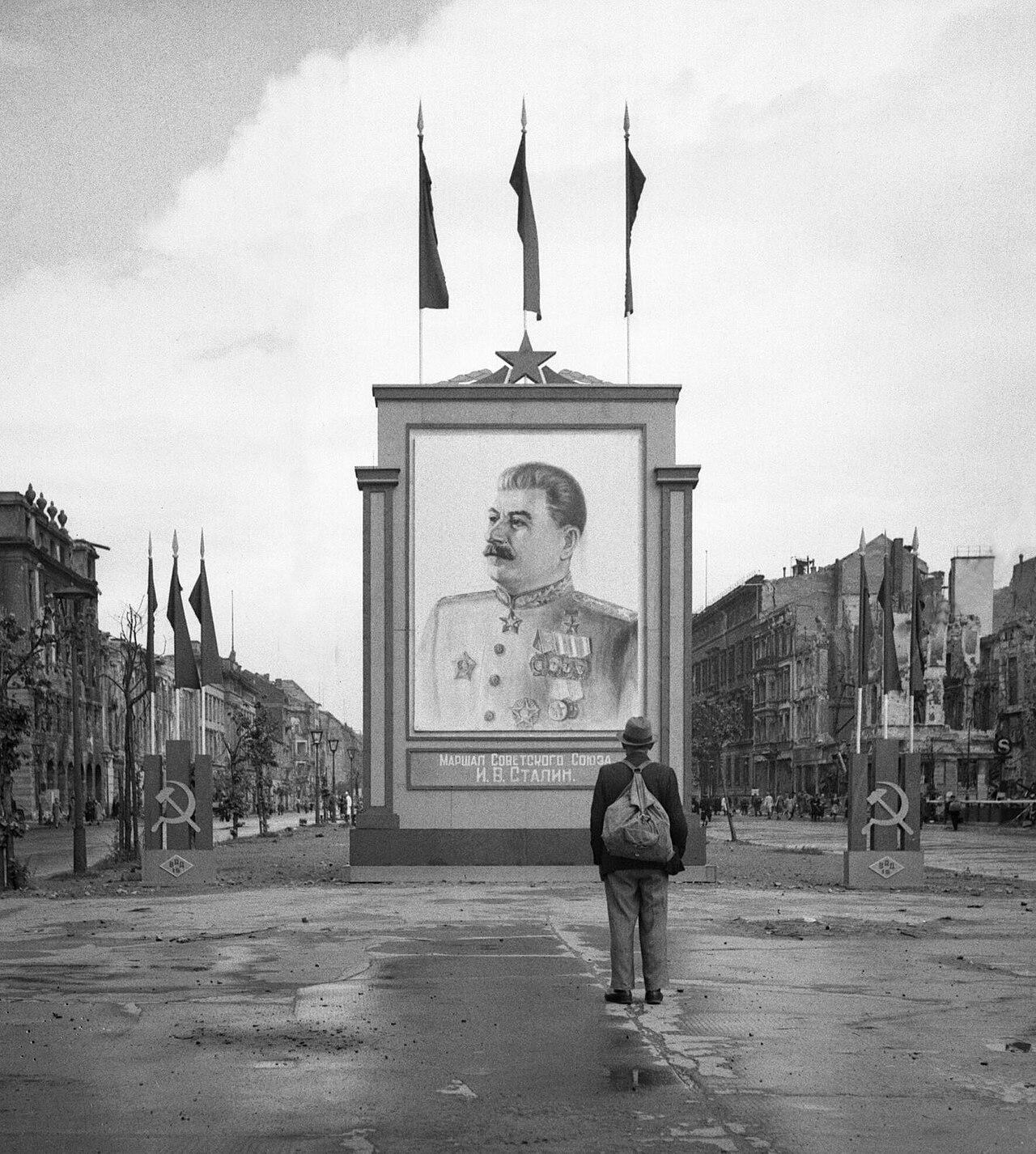 Marshal of the Soviet Union I.V. Stalin» A German civilian looks at a large poster portrait of Stalin at the center of Berlin, June 1945 : rPropagandaPosters