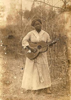 Unknown black female posing with guitar, 1890s