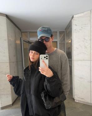 Mirror selfie in black jacket and beanie – IG May 2026